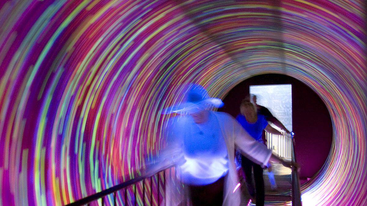 A tunnel swirls and causes folks to feel upside down at WonderWorks.