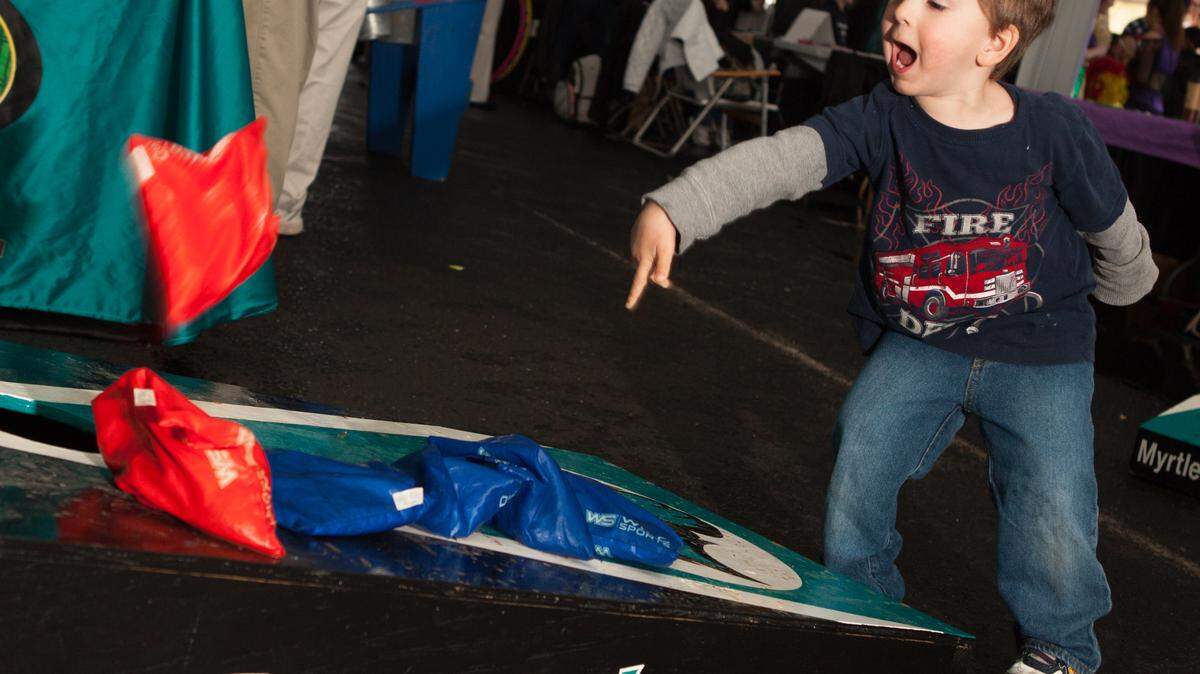Three year old Aaron Richard of Myrtle Beach tries out bean the bag toss during the 14th Annual KidzTime Festival at Broadway at the Beach Saturday, February 21, 2015. The event features free admission, live performances, fire engine rides, face painting, games, interactive activities, mascot appearances and much more.