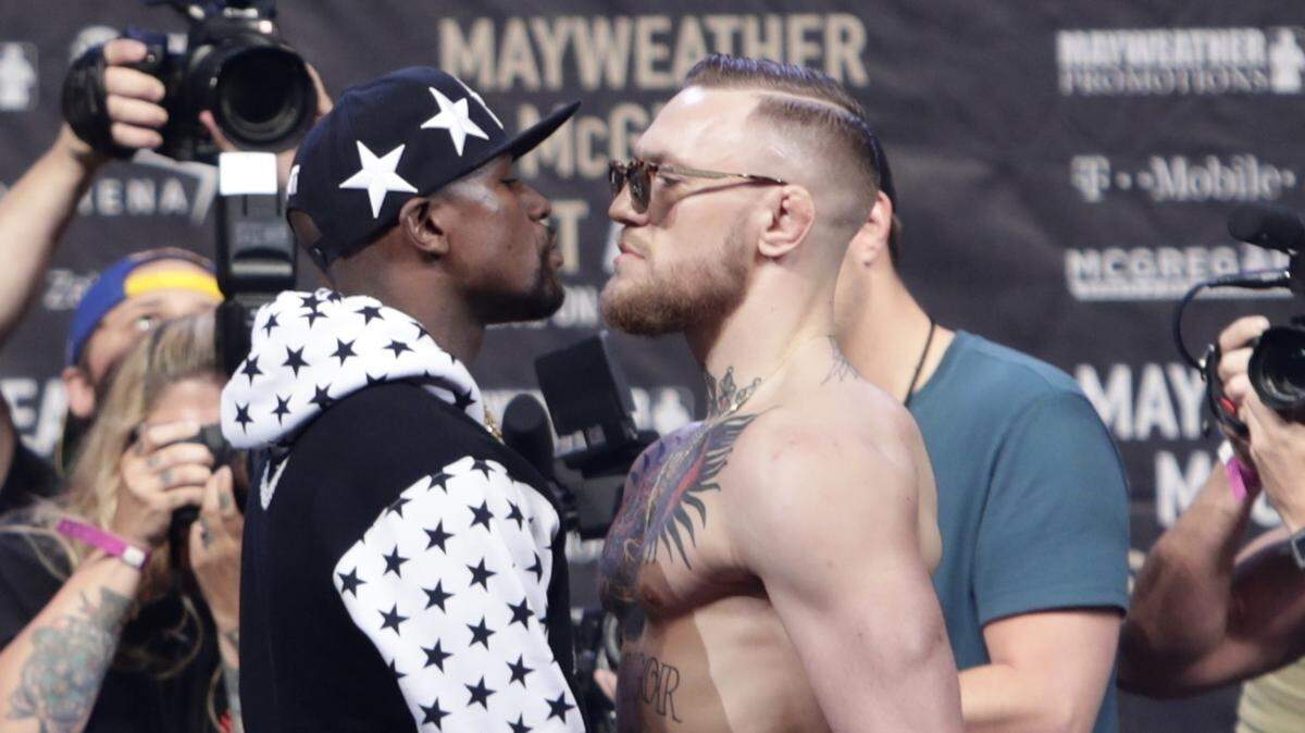 In this July 13, 2017, file photo, Floyd Mayweather Jr., left, and Conor McGregor, of Ireland, face each other for photos during a news conference at Barclays Center in New York. Nevada boxing regulators went out of their way to give a gift to both fighters, approving an exemption to the rule requiring 10-ounce gloves for the 154-pound fight so that both fighters can wear 8-ounce gloves. And just like that, the fight appeared more competitiveâ€“at least to some. (AP Photo/Frank Franklin II, File)