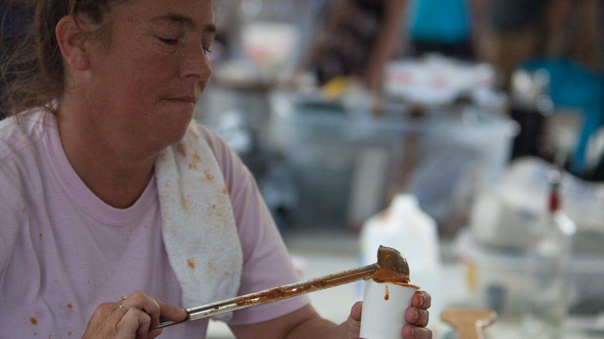 Tammy Tarte of Island Bar and Grill Pawleys dishes out chili for hungry tasters. The 16th annual Chilympics Chili Cookoff and Festival draws huge crowds from around the Grand Strand to The Hot Fish Club in Murrells Inlet Sunday, October 11, 2015.