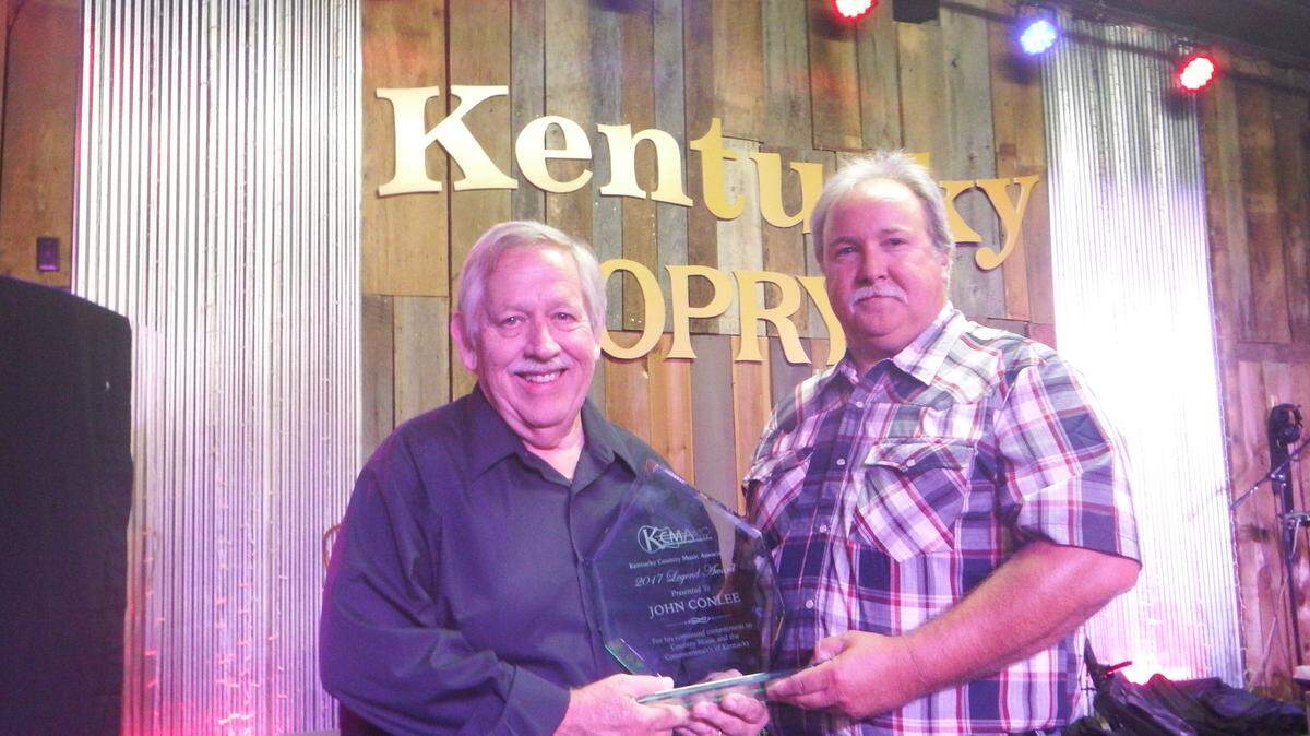 During a performance Aug. 12 at the Kentucky Opry, John Conlee (left) receives the first-ever Legends Award from the Kentucky Country Music Association, with Kenneth Reynolds, its president and founder. Known for country hits such as the debut he co-wrote, “Rose Colored Glasses,” from 1978, Conlee will play at 7 p.m. Sept. 23 at Ground Zero, 904 Chester St., Myrtle Beach. Buy tickets at 800-965-9324 or www.itickets.com/events/382830.html. More details at 843-808-4437 and www.johnconlee.com.