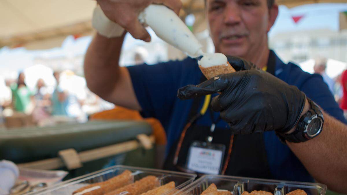 Bill Stursbug fills cannoli shells. Festa Italiana, a two-day event at Grand Park in The Market Common sponsored by the Sons of Italy Myrtle Beach, features  food, entertainment, vendors, and contests all with a distinctly Italian flair.