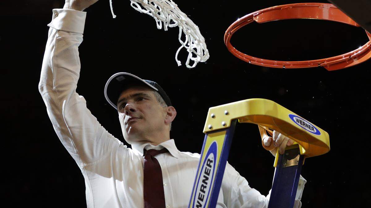 South Carolina head coach Frank Martin swings the net around after cutting it down after beating Florida 77-70 in the East Regional championship game of the NCAA men's college basketball tournament, Sunday, March 26, 2017, in New York. (AP Photo/Julio Cortez)