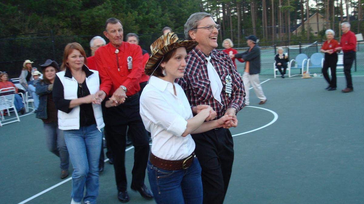 Professional square dancers The Sand Dollar Squares and Waterford Plantation neighbors join hands and promenade around the circle.

Photos by Jennifer Lombardi For The Sun News