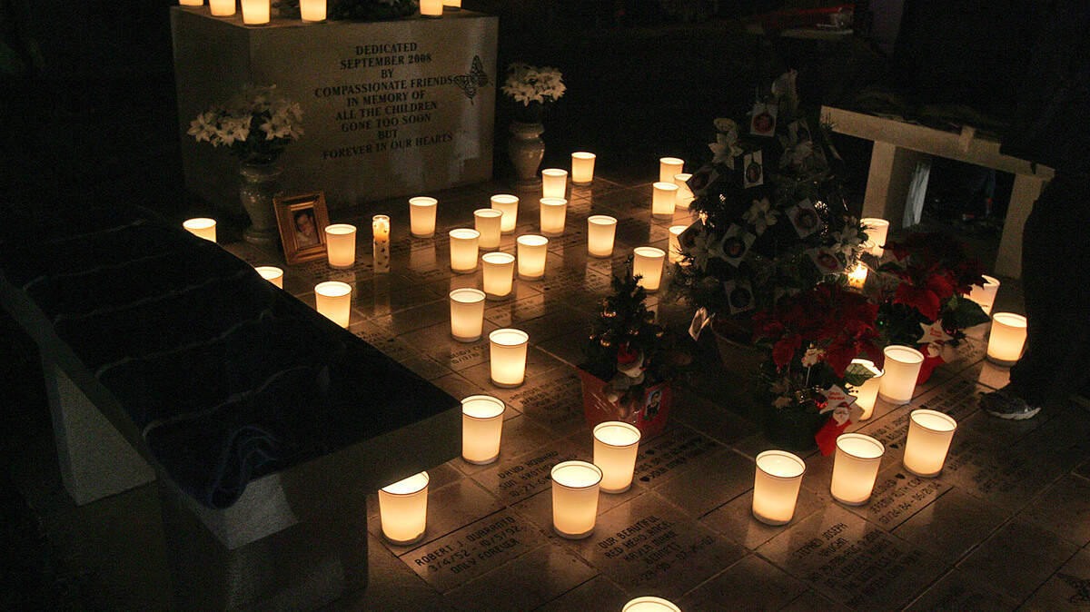 Candles are lit at Hillcrest Cemetery during the annual holiday service of remembrance for departed loved ones.