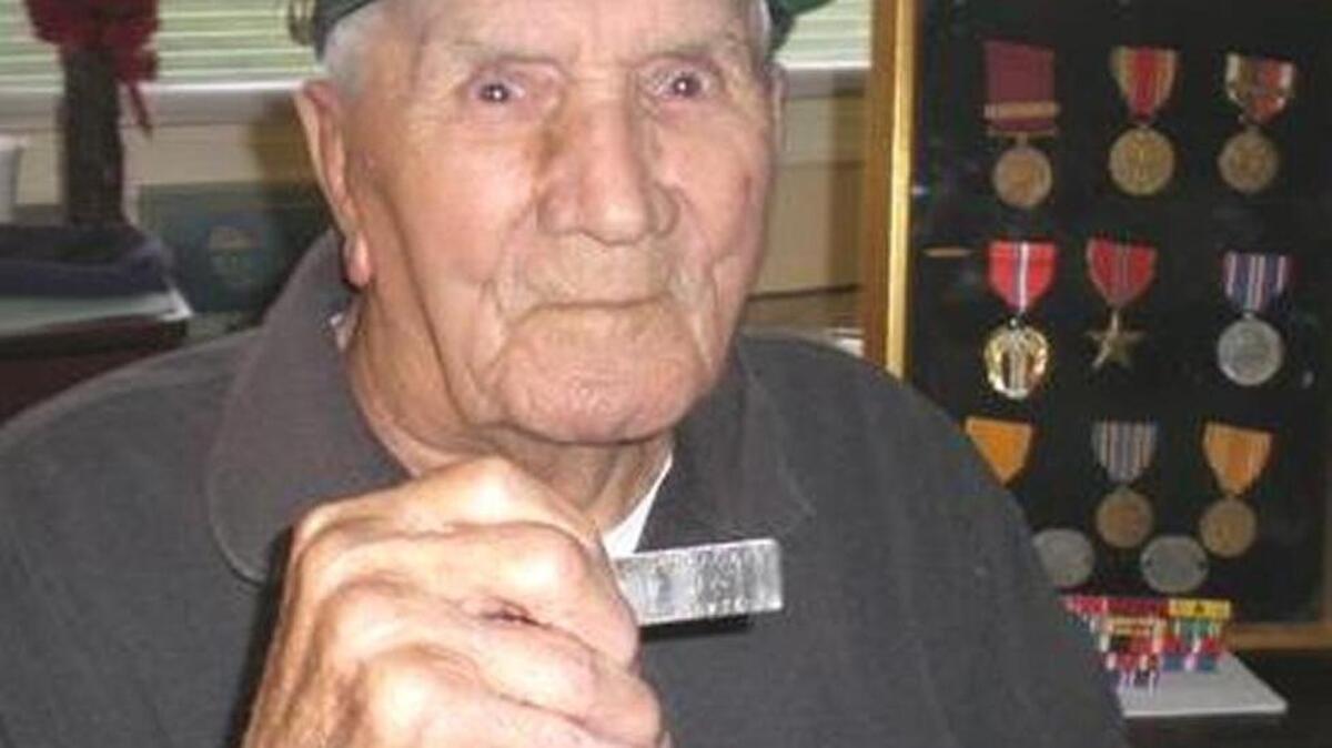 Bill Askew holding the military dog tag of Seaman Calvin Clyde McCrackin, an Horry County native. Askew will return the tags to McCrackin’s family later this month.