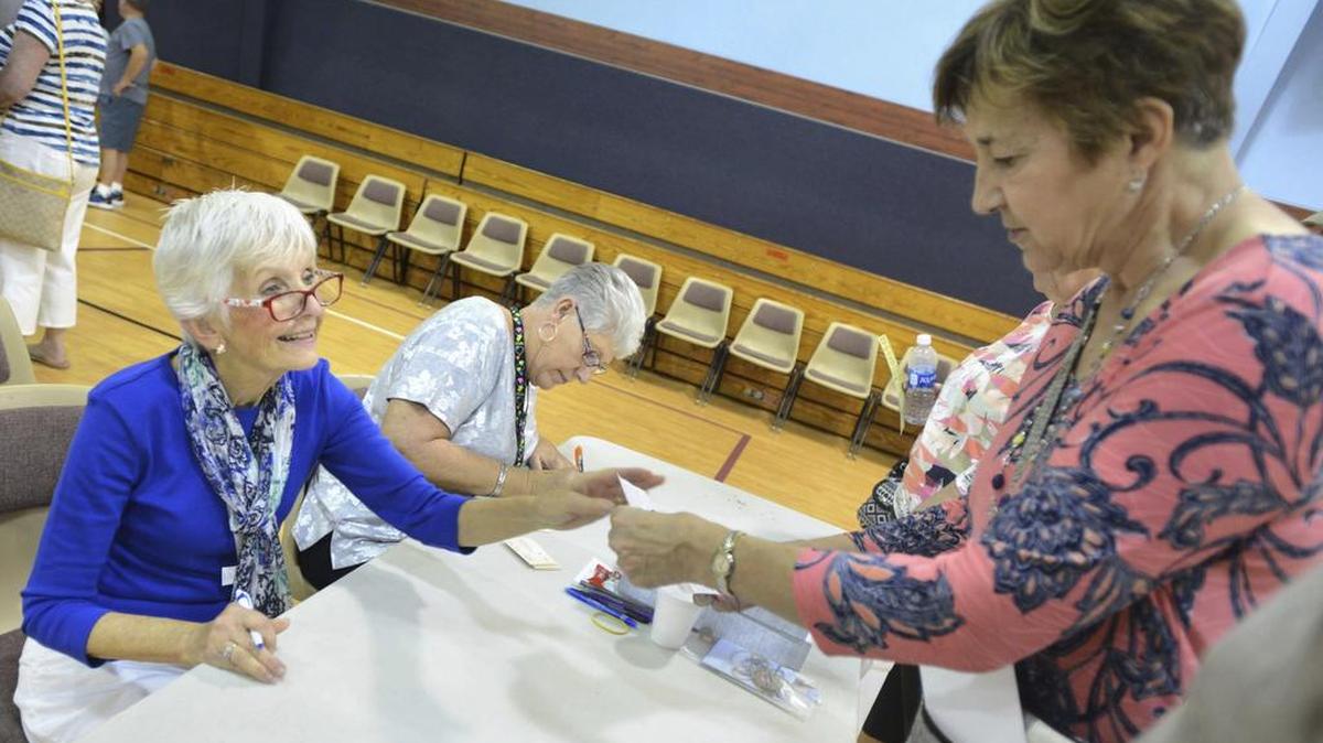 Destin, Fla., Snowbird Club volunteer Carole Norton, left, helps Nebraska snowbird JoAnn Thompson register for the club earlier in January at the Destin Community Center in Destin, Fla. Visitors from northern states and Canada come down to Northwest Florida every year for one to three months to escape winter weather, as is the case in Myrtle Beach.
