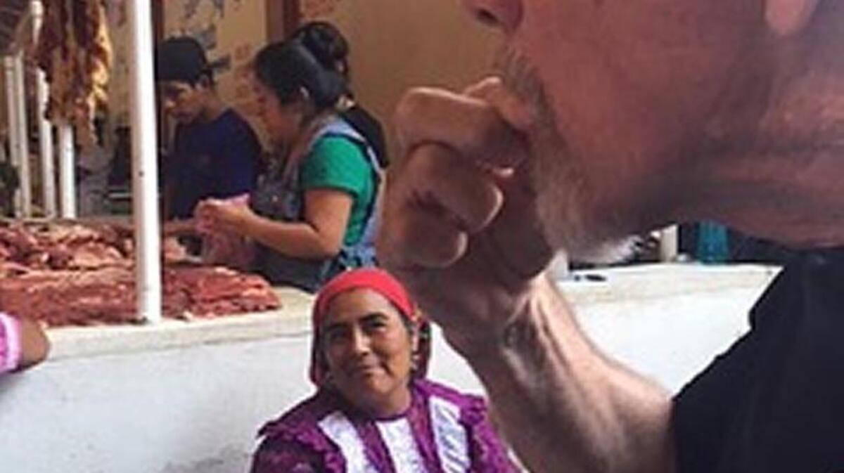 Photographer Tom Murray tries chapulines, or grasshoppers.