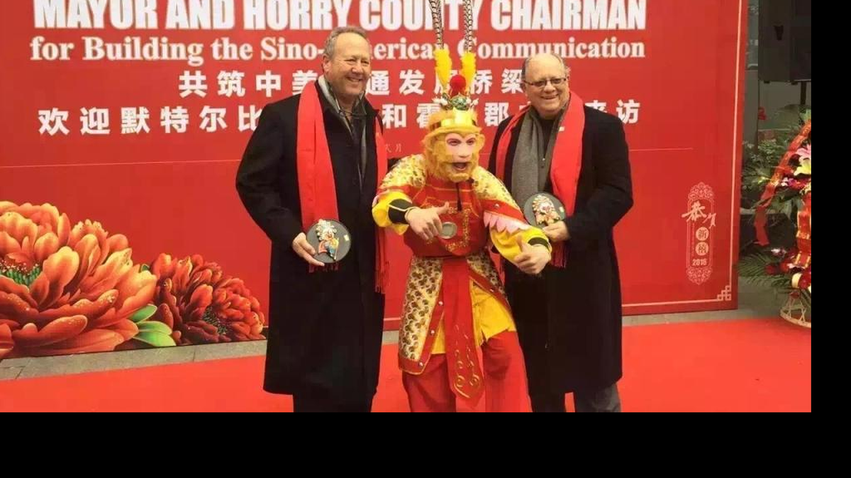 Horry County Council Chairman Mark Lazarus (left) and Myrtle Beach Mayor John Rhodes take part in a ceremony during their recent economic development trip to China.