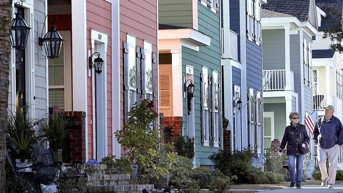 
A couple walks past some of the homes in The Market Common area of Myrtle Beach on Friday, Jan. 16, 2015. June’s single family home sales for Horry and Georgetown counties increased by nearly 18 percent from the same month in 2014.
