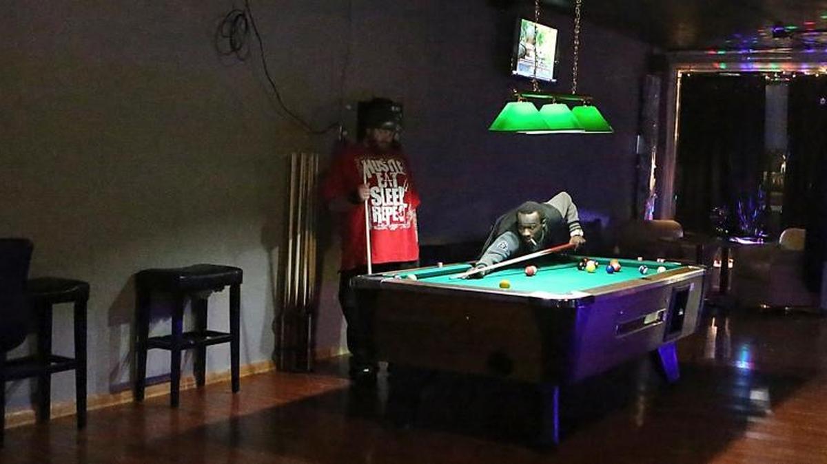Reginald McCray takes a shot as Blake "Bam" McCarty (left) hopes a solid drops at Natalias Bar & Grill in the Superblock of Myrtle Beach early Friday, Dec. 4, 2015. Myrtle Beach City Council continued part of an ordinance that would require bars and nightclubs to close at 2 a.m.