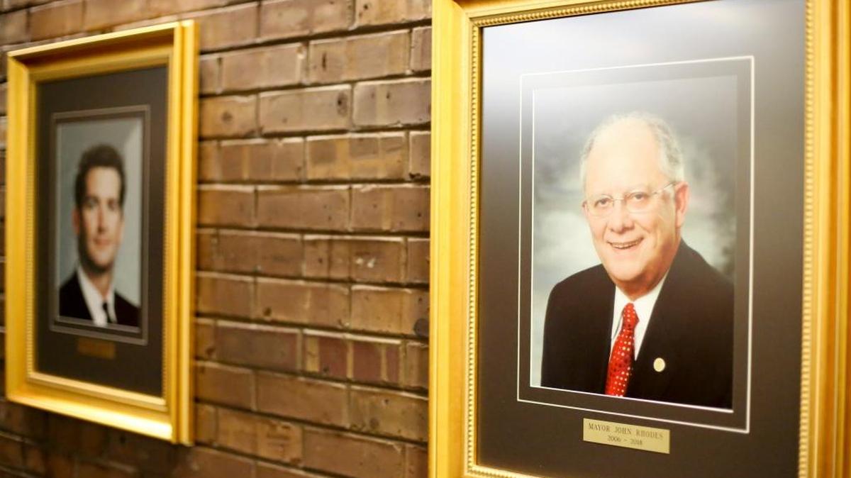 There are new portraits hanging in City Hall of former mayors Mark McBride and John Rhodes.