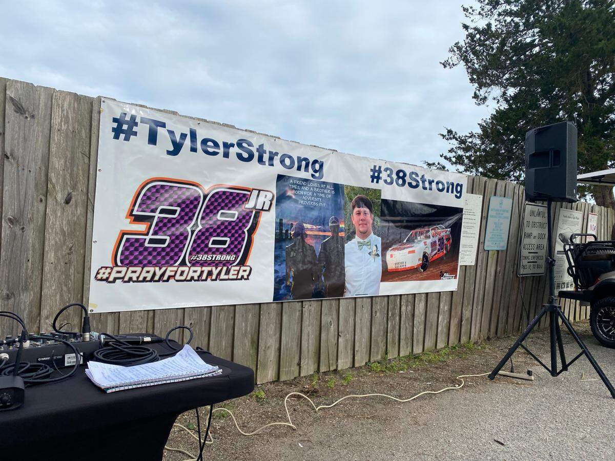 A banner depicts missing South Carolina boater Tyler Doyle, with the words “Tyler Strong” on it. Hundreds gathered at a prayer vigil Sunday night at the T. Craig Campbell Boat Landing to show support for the Doyle family. Photo from Feb. 19, 2023.