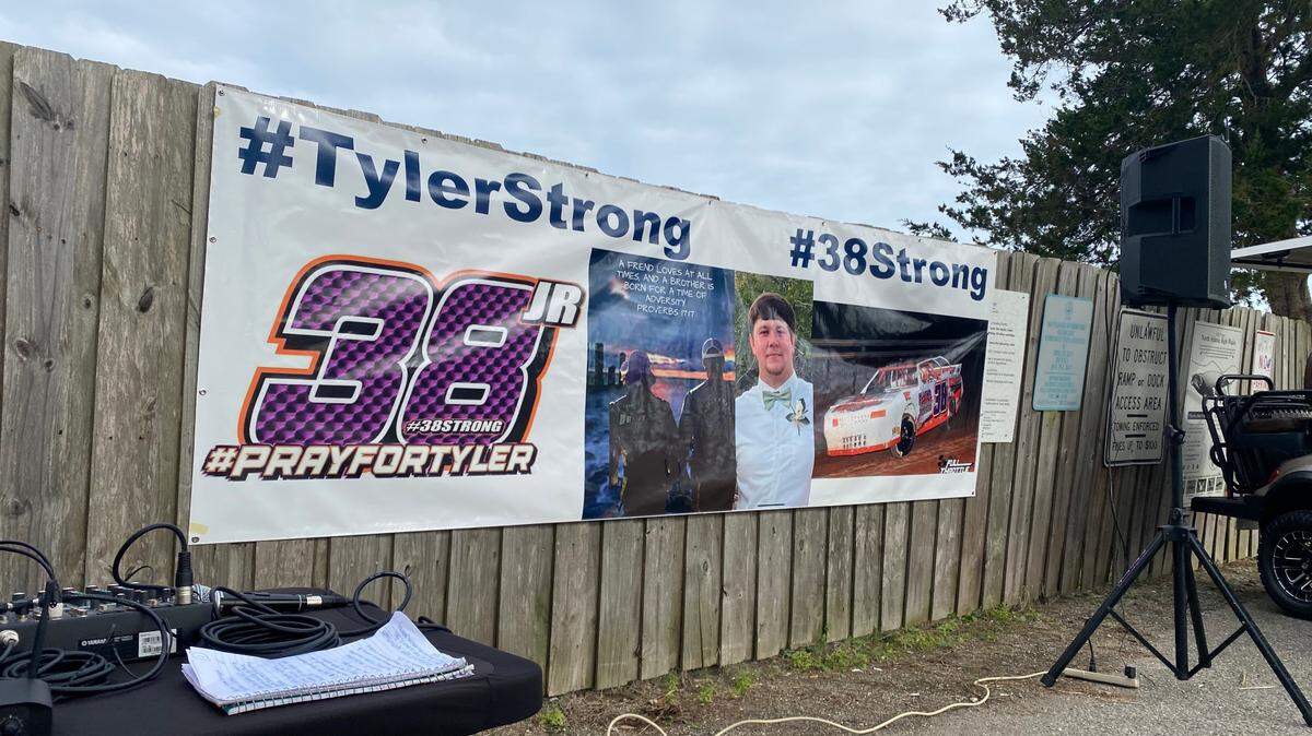 A banner depicts missing South Carolina boater Tyler Doyle, with the words “Tyler Strong” on it. Hundreds gathered at a prayer vigil Sunday night at the T. Craig Campbell Boat Landing to show support for the Doyle family. Photo from Feb. 19, 2023.