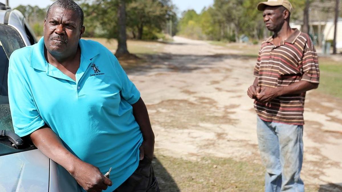Brothers Nathan (left) and Issaac Livingston navigate the more than 150 potholes on the 0.2-mile Bills Place dirt road off S.C. 90 last Thursday. They said they have repeatedly asked the county to scrape the road, but were told Horry County considers the road a private road and will not scrape it. Nathan Livingston said he's offered to pay the county road crew scraping nearby roads if they would scrape Bills Place. Issaac Livingston said his home on the dirt road burned down a few years ago and he blames the pot holes for delaying the fire trucks being able to fight the fire.