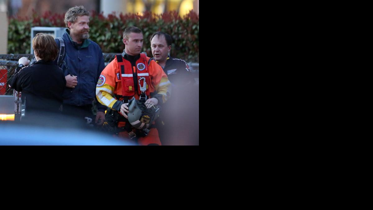 
Louis Jordan, second from left, walks from the Coast Guard helicopter to the Sentara Norfolk General Hospital on Thursday, April 2, 2015. His family says he sailed out of a marina in Conway, S.C., on Jan. 23, and hadn't been heard from since. (AP Photo/The Virginian-Pilot, Steve Earley)
