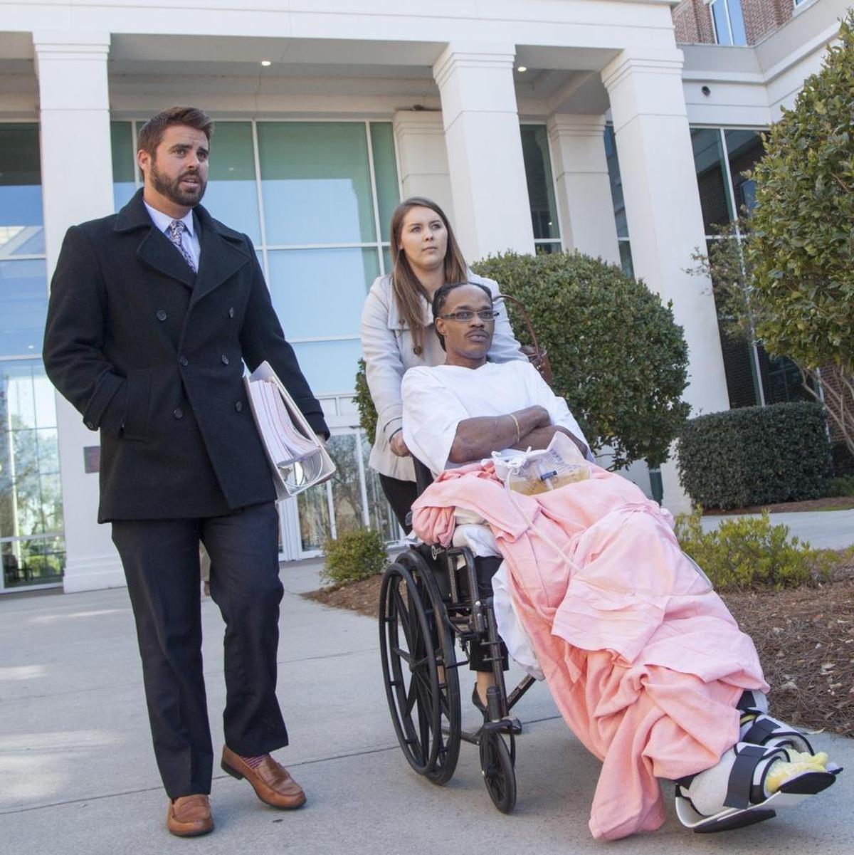 Julian Ray Betton is wheeled from the Horry County Courthouse after he pled guilty Thursday, Mar. 16, 2017, to two drug charges. Five other charges lodged against him, including three counts claiming Betton pointed a gun at the officers who shot him nine times, were dropped in a plea deal. Judge Larry Hyman, Jr., sentenced Betton to five years for each charge, but suspended the sentences for “time served.” “Today was an absolute victory for Julian and for the people of South Carolina to know who’s watching the watchers,” said his attorney, Jonny McCoy. Betton has filed a lawsuit against the 15th Circuit Drug Enforcement Unit and the officers who shot him, claiming the agents entered his home without announcing they were police and gunned him down without him ever firing a weapon. Betton is now paralyzed from the waist down as a result of that raid on April 16, 2015.