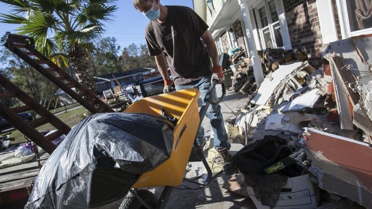 David Barickman removes debris from a home in Socastee’s Rosewood Estates in this file photo, where numerous homes were inundated with flood waters after Hurricane Matthew.