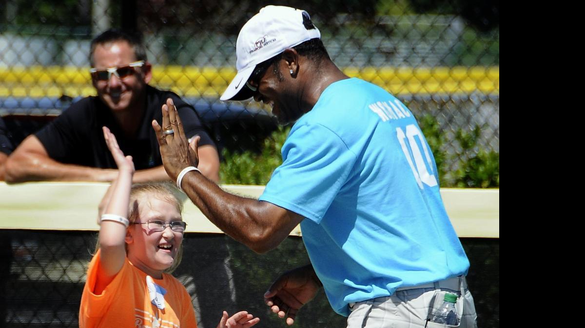 
Former MLB player Tony Womack high fives his Miracle League player partner Friday morning. The athletes participating in the second annual 2LiveBeyond Celebrity Golf Tournament on Saturday at the Grande Dunes Members Club took part in a game with Miracle League participants Friday morning at the Miracle League Field.
