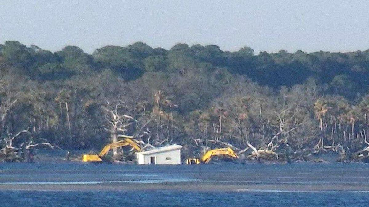 The last standing cabin off Hunting Island, known as Little Blue, was brought down by excavators on Thursday, Feb. 16, 2016 as they worked from a sandbar at low tide according to Jonathan Wilson. Wilson, who was fishing at the time, said that after he took this photo and glanced back, the cabin was demolished.