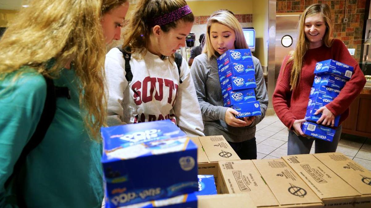 South Carolina students from left, Eliza Lynch, 19, Lily Houston, 18, Kacey Elman, 18, and Katie Morgan buy boxes of pop tarts and granola bars at the dining commons, Wednesday, December 9, 2015. USC students used their leftover meal plan dollars to buy food and donate it to the Oliver Gospel Mission, Wednesday, December 9, 2015.