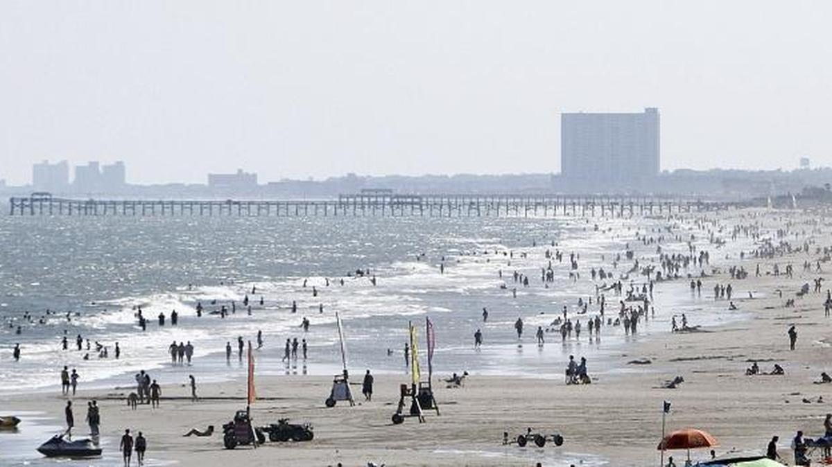 Sunbathers and swimmers spend the last few days of summer in Myrtle Beach in 2014.