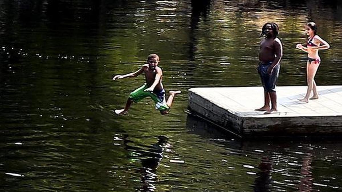 
Elijah Ayers jumps in the Waccamaw River at Reaves Ferry Landing in July 2014. 
