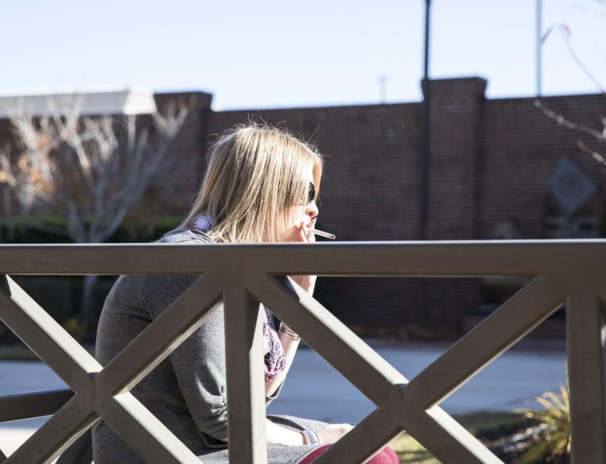 An Horry county employees smokes in the courtyard of the Judicial Center on Tuesday. If a proposed law passes, tobacco use would be banned outside county buildings. Nov. 28, 2017