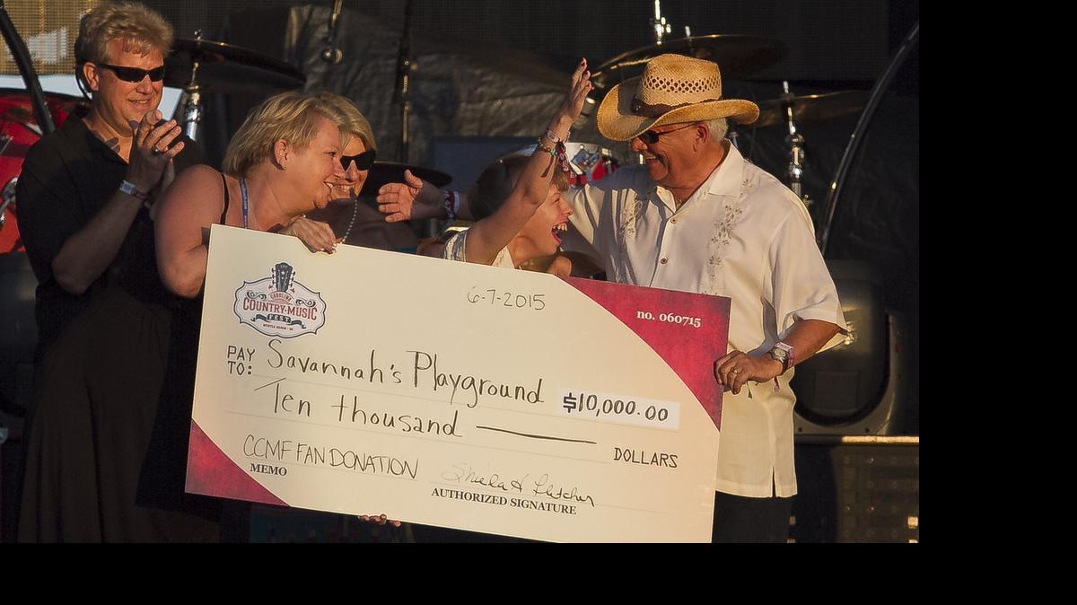 
Savannah Thompson receives a check with Mayor John Rhodes for Savannah's Playground from the Carolina Country Music Fest donations. The last day of the Carolina Country Music Fest in Myrtle Beach is Sunday, June 7th with top country artists such as Marshall Tucker Band, Kellie Pickler, Hunter Hayes and Lady Antebellum performing their hits on the Jack Daniels stage at the Boardwalk.
