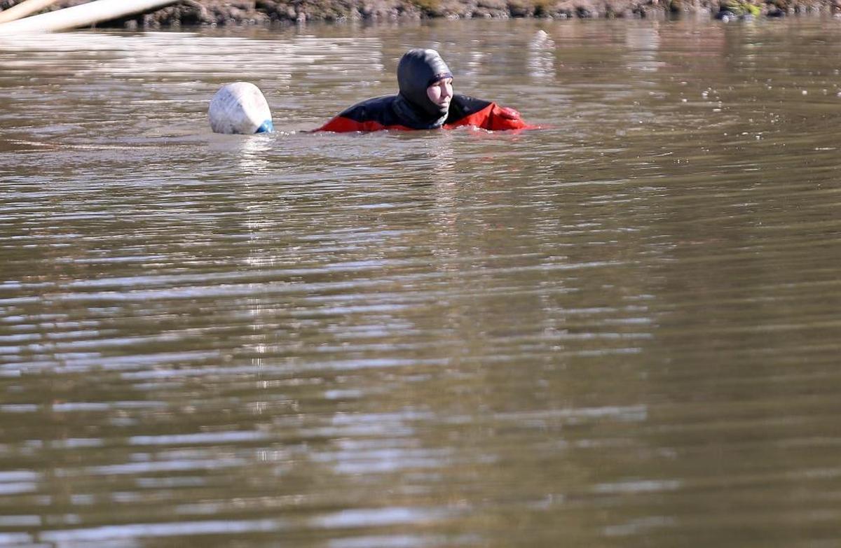 Horry County Fire Rescue divers search a pond on Hulls Island Road in the Longs community Saturday morning. By 12:30 p.m., two bodies and a vehicle were removed from the irrigation pond. Capt. Mark Nugget, spokesperson for Horry County Fire Rescue, said crews were called to the scene around 2:30 a.m. after a report of a car in the pond. The search resumed around 11 a.m. Saturday. A man who lives near the pond said he heard a noise and looked to see a car sinking in the pond. He said he did not see any one coming out of the pond. The man, who asked not to be identified, said the pond is spring-fed and used to irrigate nearby fields. The pond's depth graduates from around 10 to 12 feet at the end where the bodies and vehicle were found and as deep as 18 feet.