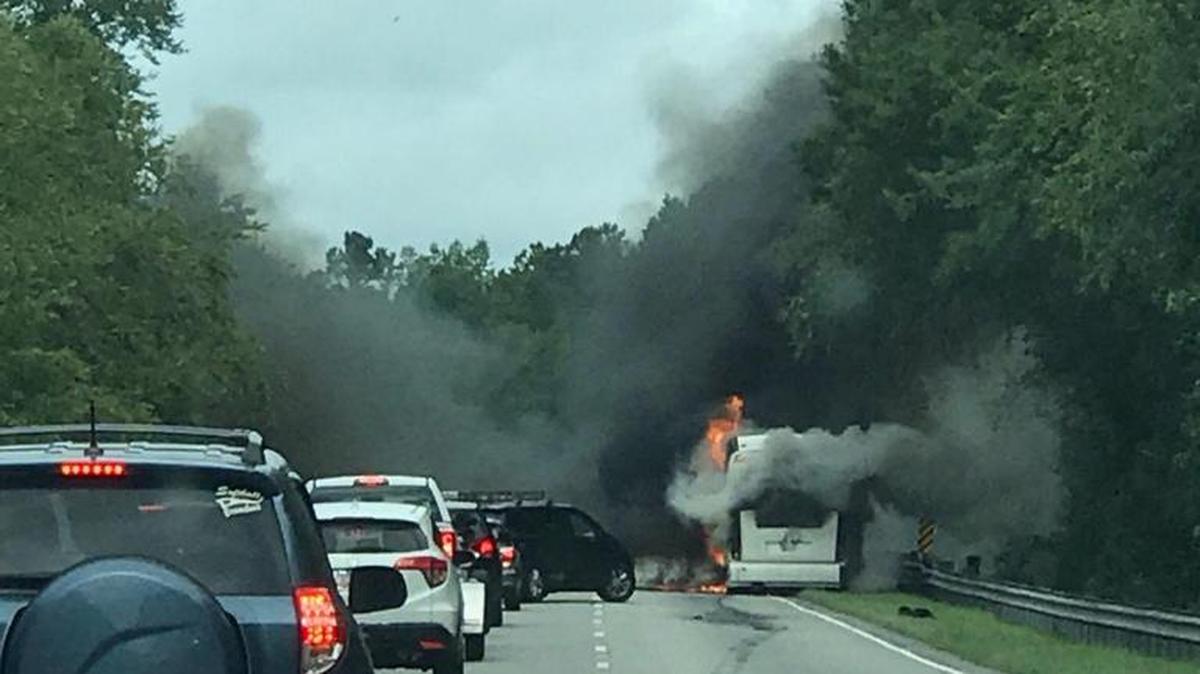 This photo submitted by Loir Oliff of Stafford, Va. shows a tour bus on fire in the northbound lanes of U.S. 501 near Galivants Ferry.