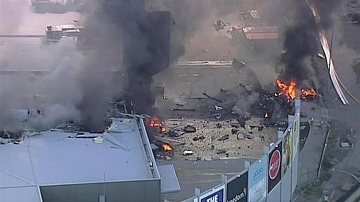 This image made from video shows the site of a plane crash at Essendon Airport in Melbourne, Australia Tuesday, Feb. 21, 2017. An official says a light plane has crashed into a shopping mall in the city of Melbourne.