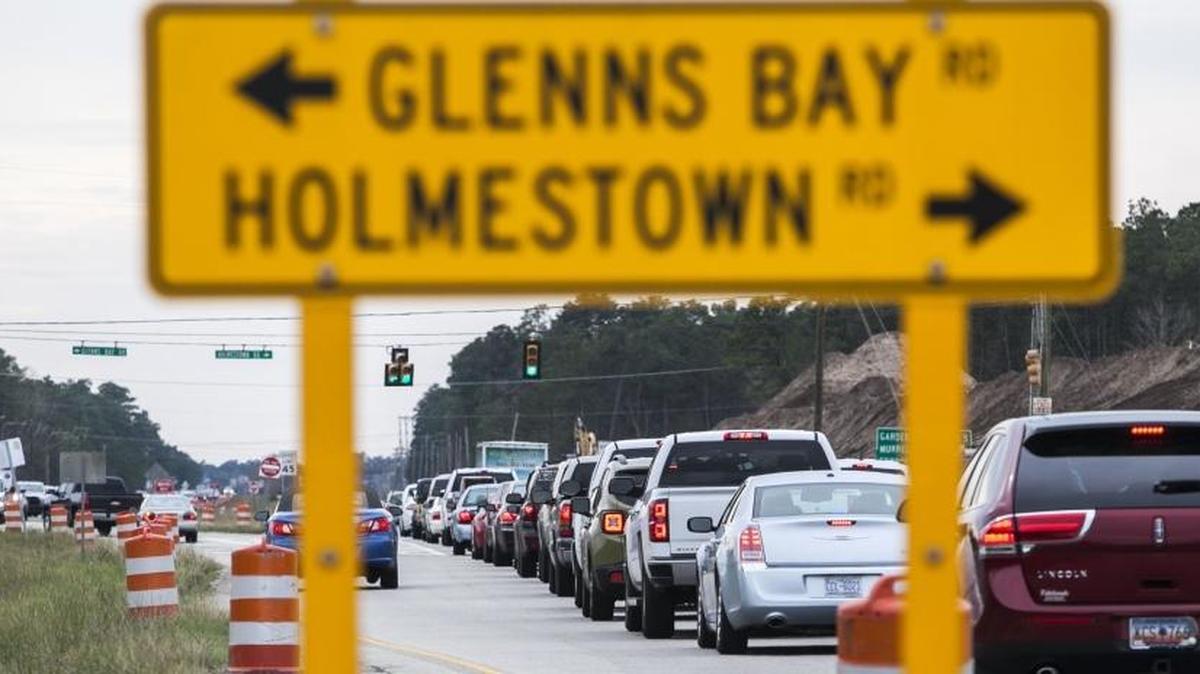 Traffic builds at the intersection of Glenns Bay and Holmestown Rd. where the widening and interchange construction project is ongoing. Utility work is behind schedule, but not expected to delay completion set for 2017.