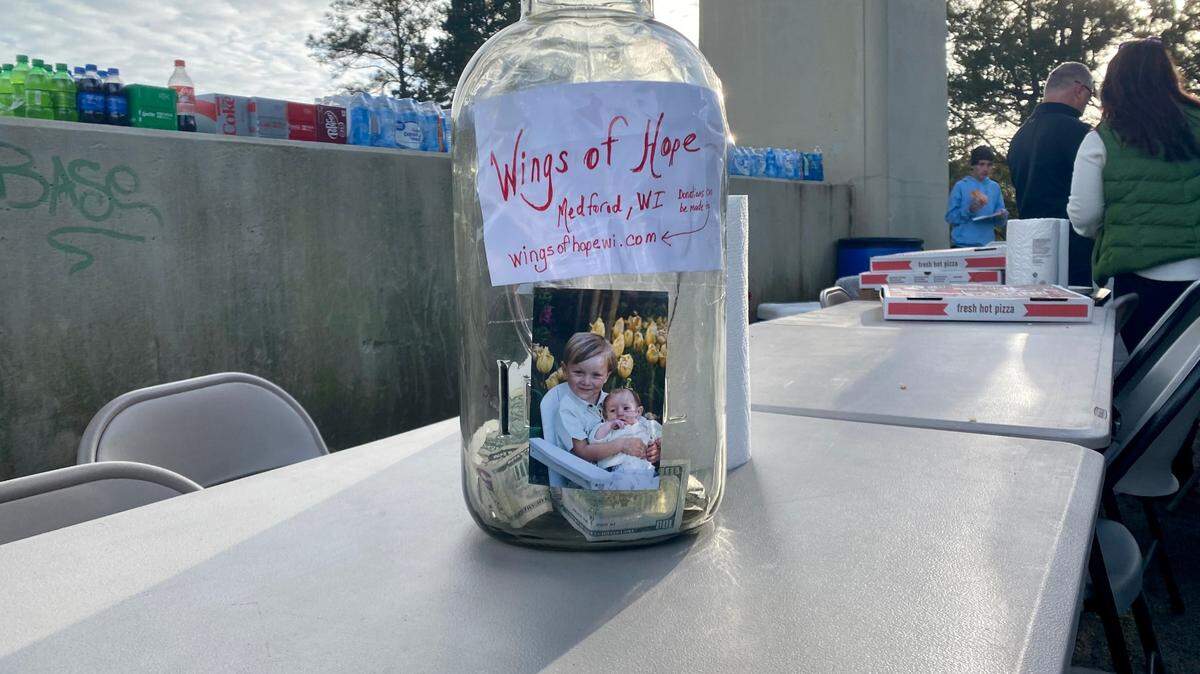 A cash donation jar from nonprofit Wings of Hope sits on a table at a prayer vigil held for missing SC boater and duck hunter Tyler Doyle. Hundreds gathered Sunday evening for prayer, food, and duck calling. Photo from Feb. 19, 2023