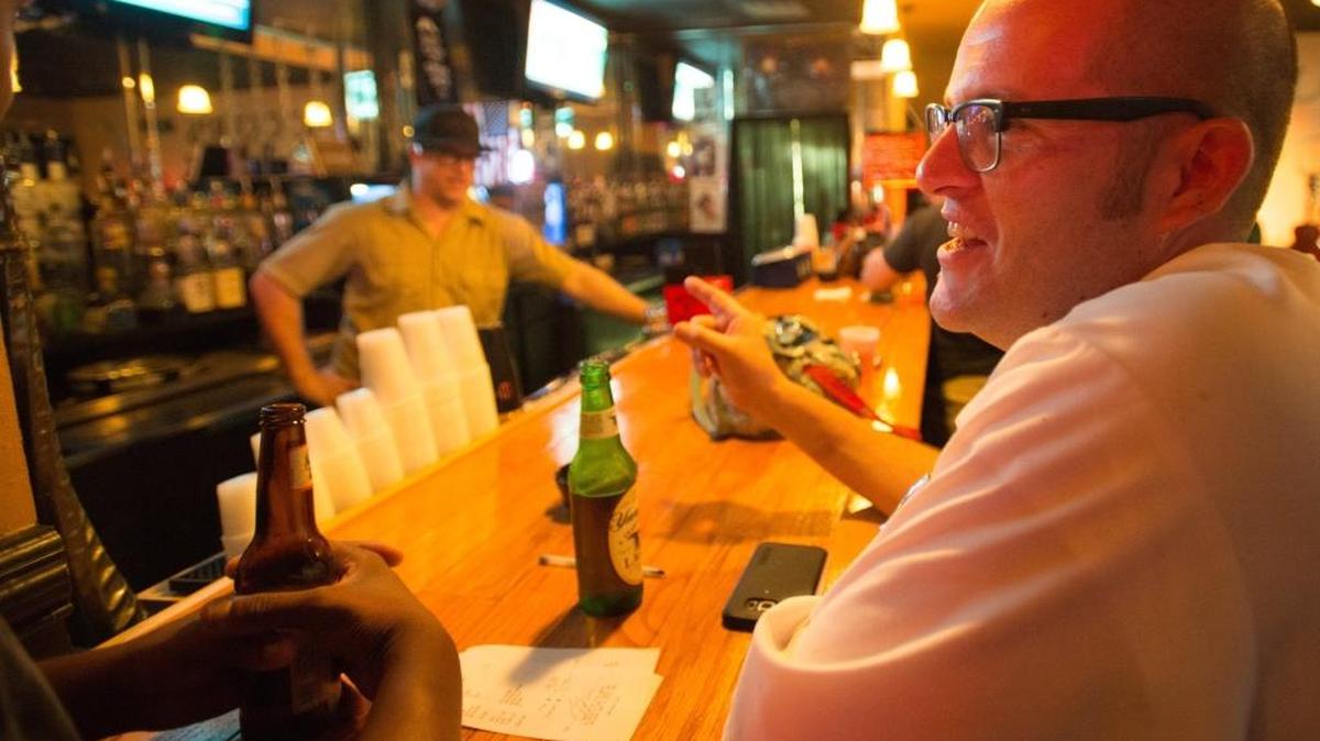 Henry Friese Mills has a beer and chats with friends at Klockers Bar after getting off work at a local restaurant late.