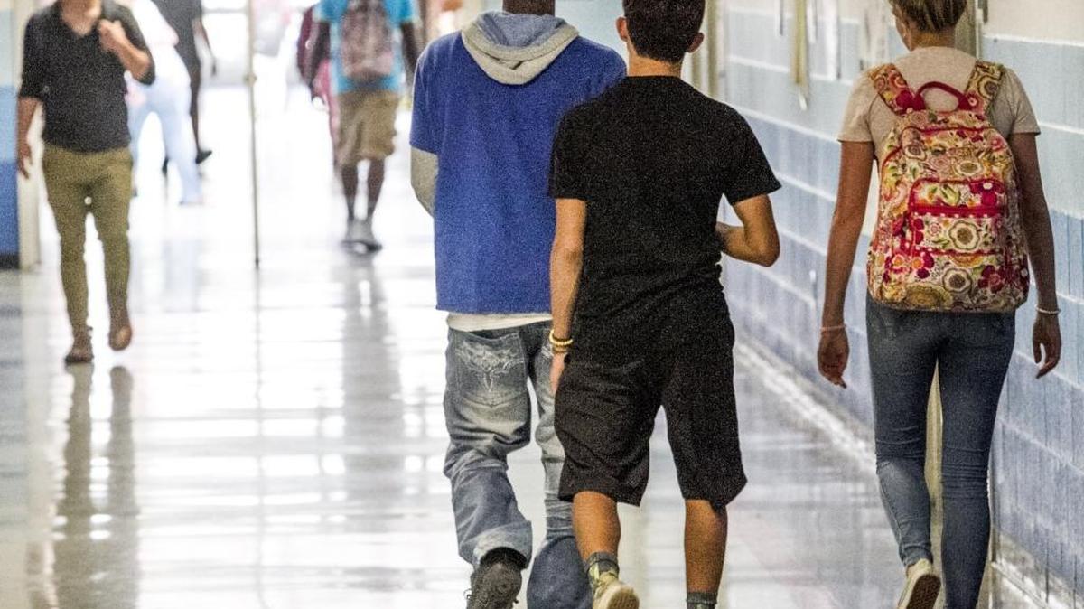Students stream through the halls between classes at St. James High School on Tuesday.