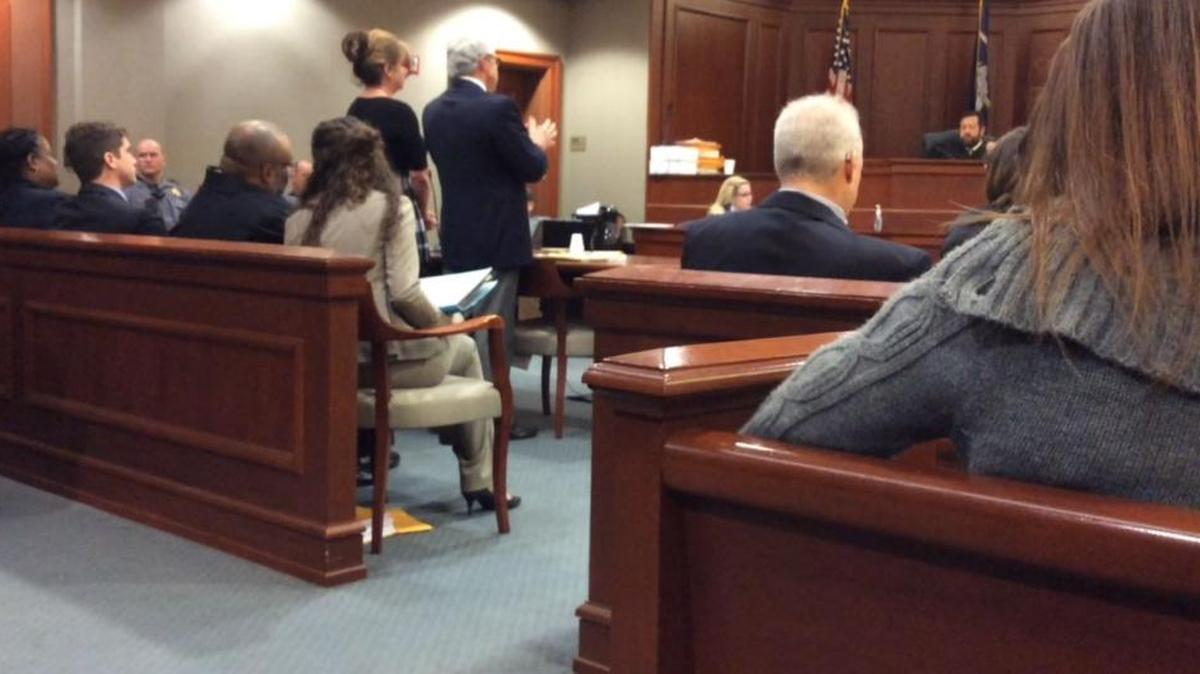 Alicia Altman, the woman in the dark dress, stands as Judge Robert Hood sentences her to two and a half years in prison.