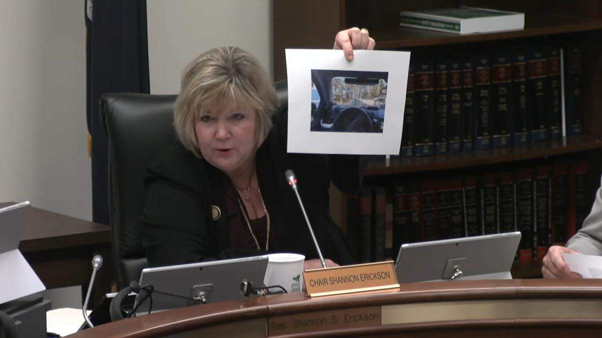 SC state Rep. Shannon Erickson, R-Beaufort, holds a photos of a low-riding truck commonly known as “Carolina squats” during a March 28, 2023 Education and Public Works committee meeting.