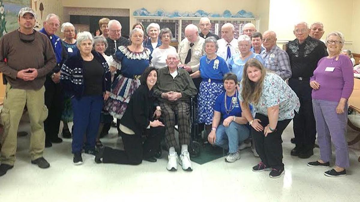 Harold Dyson, an avid square dance caller and dancer for many years (seated in middle), with Sarah Dellinger (kneeling to his right), Lower Cape Fear Hospice Mercy Care’s community outreach coordinator for Horry County, are surrounded at Kingston Nursing Center by members of the Grand Strand Strutters and Round Dance Club. The entourage fulfilled his wish to attend and participate in a square dance one more time.