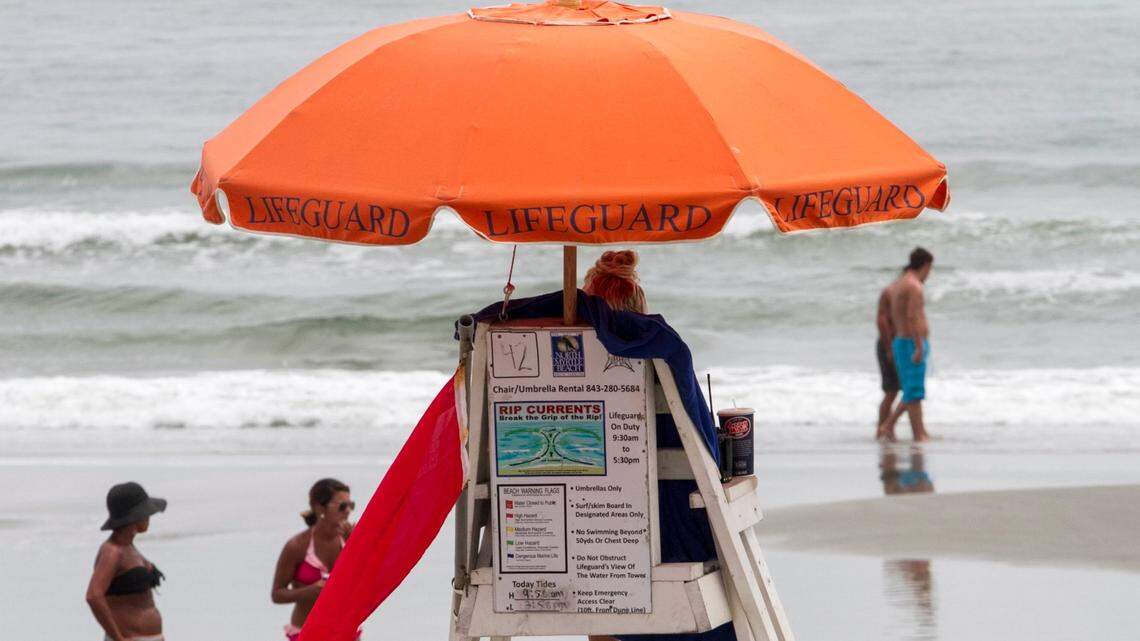 A lifeguard watches over the water in this Sun News archival photo. Experts say a dual role system used by Myrtle Beach is dangerous.