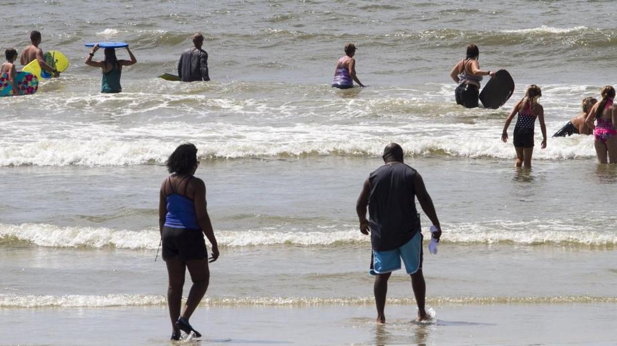 Swimmers re-enter the water a short time after reports Friday of a possible shark bite at 27th Avenue North in Myrtle Beach. Myrtle Beach fire and police were called about 10:15 a.m. to the beach around 27th Avenue North where a man suffered an injury to his foot while swimming, but police said they were unsure if the man was bitten by an animal. The victim told authorities he didn't see any fish or animals around when he suffered the injury to his foot, and authorities can't say for sure what injured the man's foot.