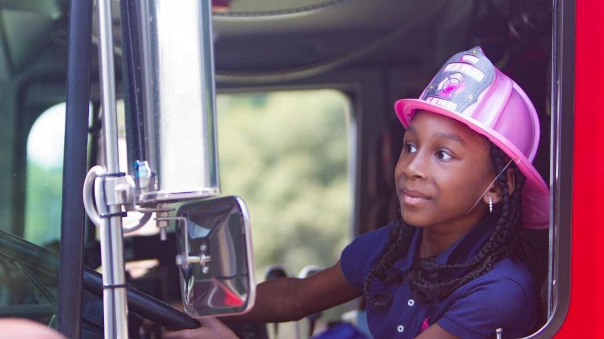 
7-year-old Hannah Oakman looks in the mirror to see the lights on the fire truck. Jason's House is a nonprofit organization provides vacations to families of sick children. Recipients meet in Fellowship Hall at Surfside United Methodist Church, pick out toys, snacks and shells, meet firemen from the Surfside Fire Department and cruise with the Grand Strand Corvette Club.
