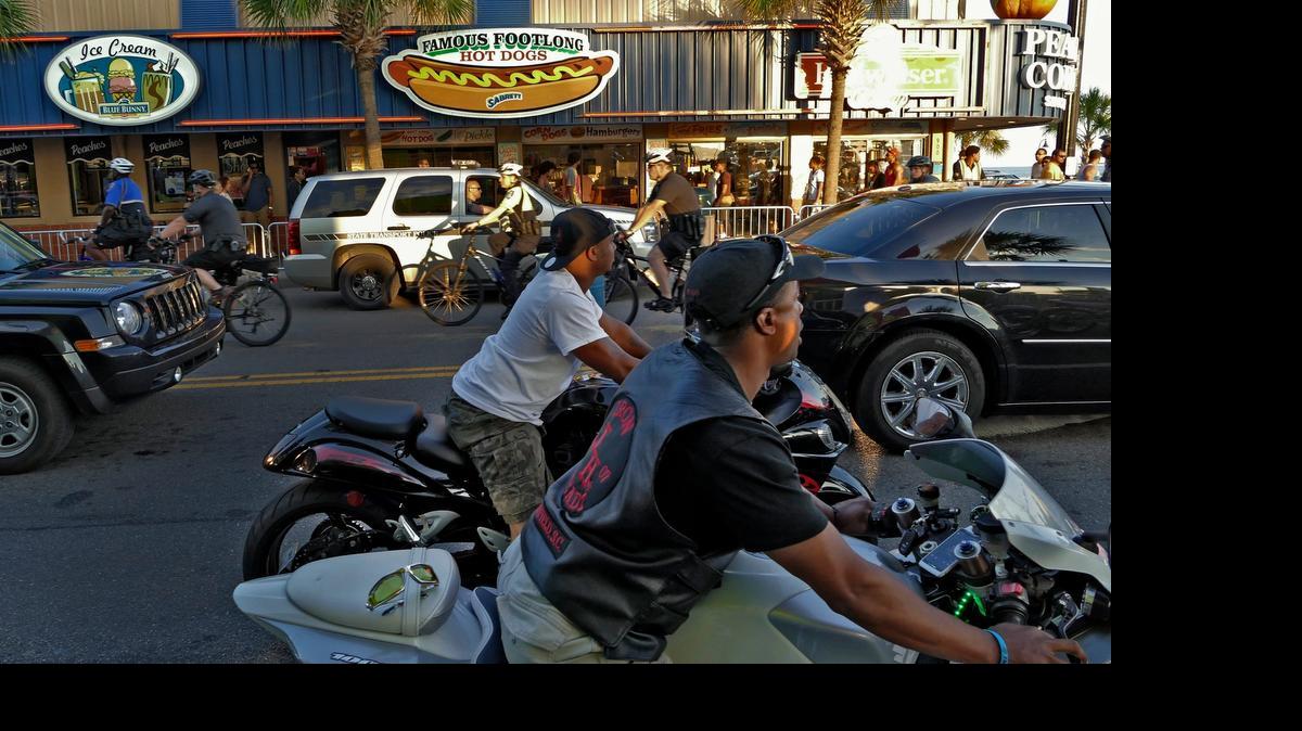 
A group of bicycle officers ride north on Ocean Boulevard as traffic moves slowly south Friday evening as the Atlantic Beach Bikefest gets underway.
