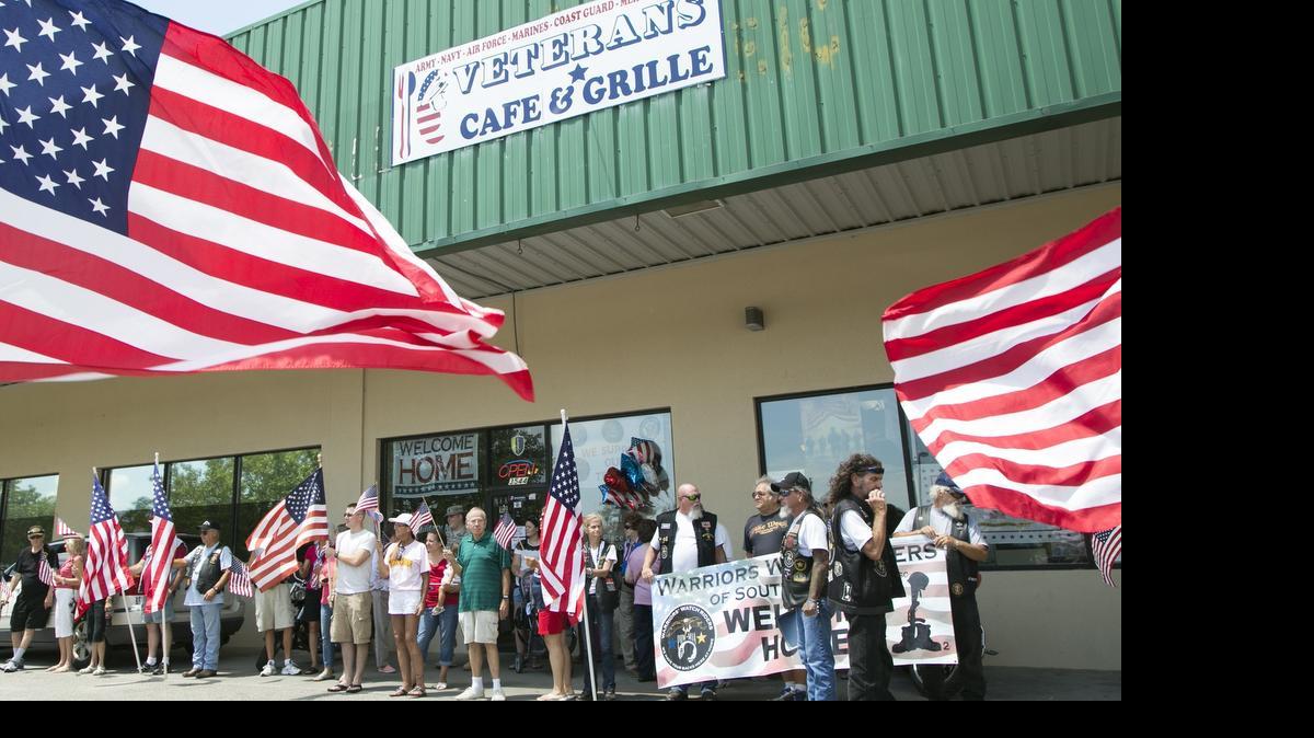 
Veterans support organizations form a "flag line" in front of Veterans Cafe & Grill waiting to welcome four generations of veterans in Myrtle Beach for vacation. Four generations of veterans, in Myrtle Beach for a family reunion, were honored Thursday by veterans support organizations at the Veterans Cafe and Grille. The honorees included: Martin Caudill, Alabama National Guard, Joseph Caudill, U.S. Army PVC serving in Korea, Bill Smith, Air Force Master sergeant serving in Vietnam, Martin Caudill, Air National Guard, and Jonathan Carr, Army Specialist who served in Afghanistan.
