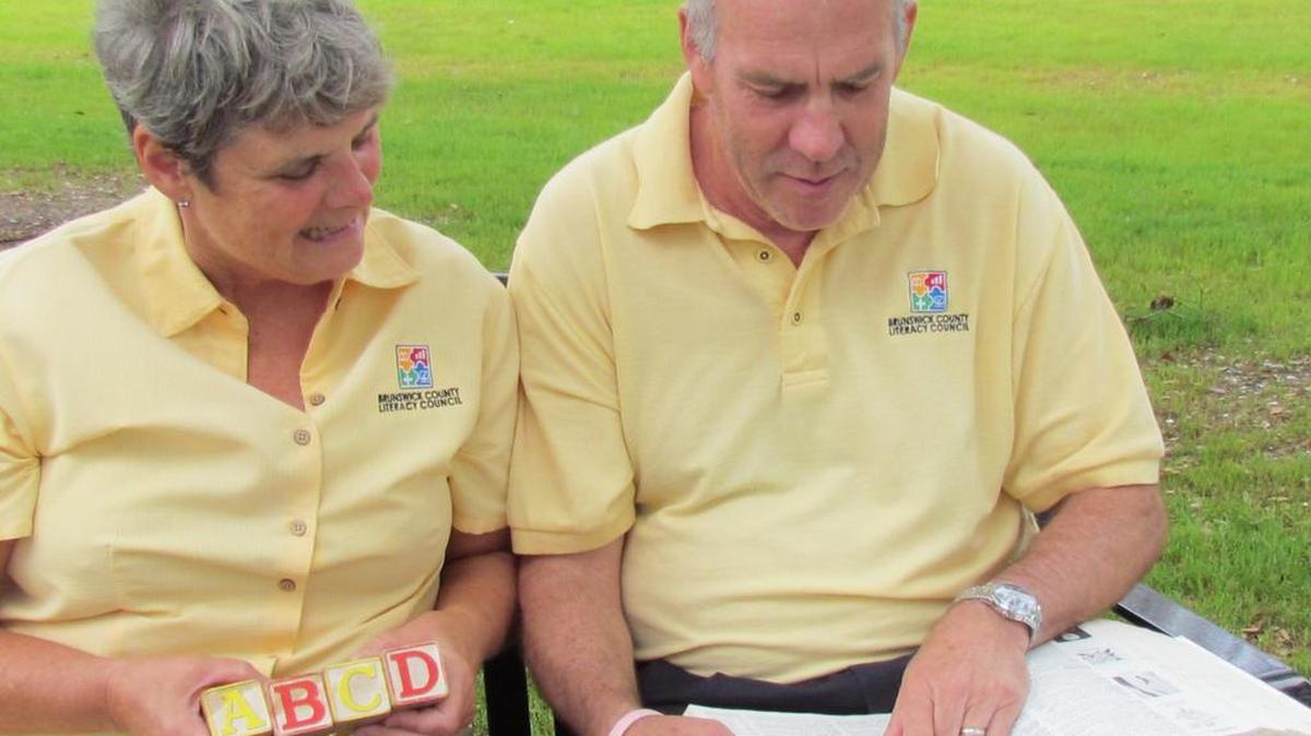 Kim Loucks and his wife Carolyn Hirst-Loucks choose appropriate words for the 28th annual Adult Spelling Bee, a Brunswick County Literacy Council fundraiser. Five years ago the council added the popular A to Z silent auction, and this year will have costume and cheering section contests.