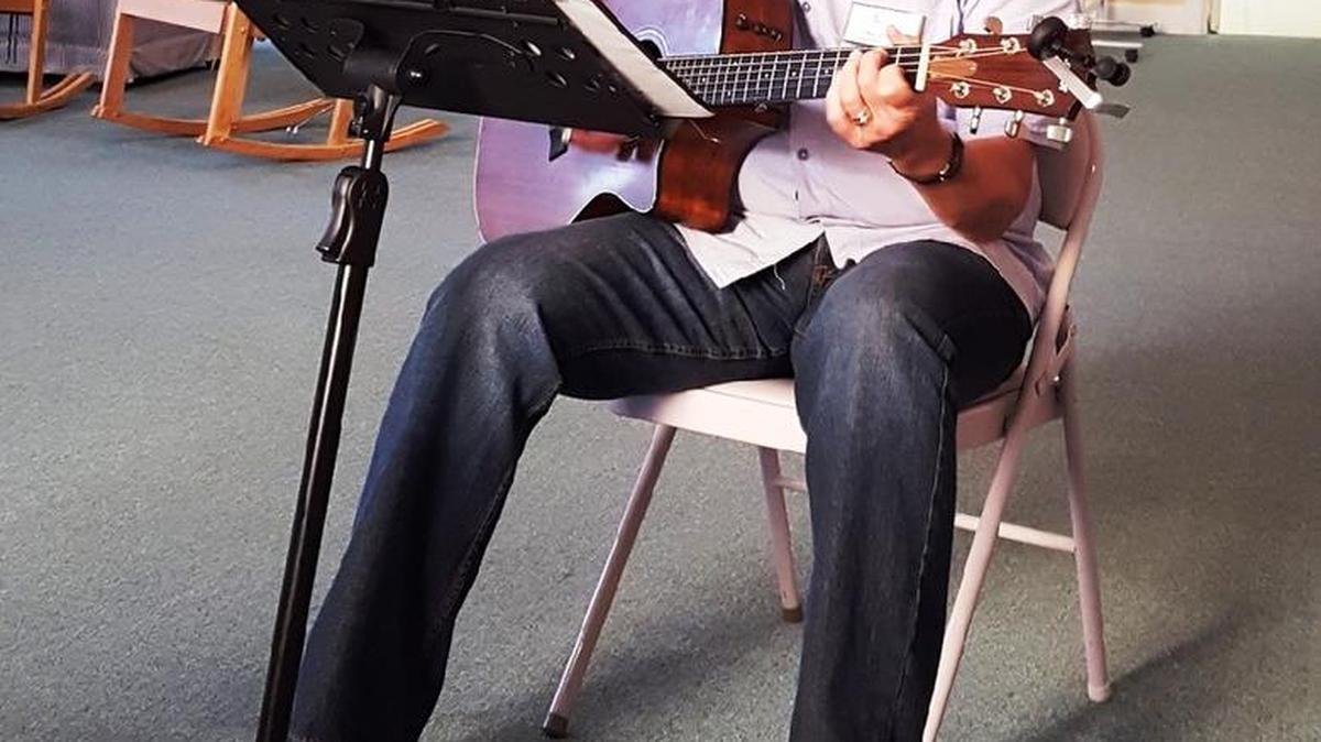 Charles Gee entertains Tidelands Respite Care participants.