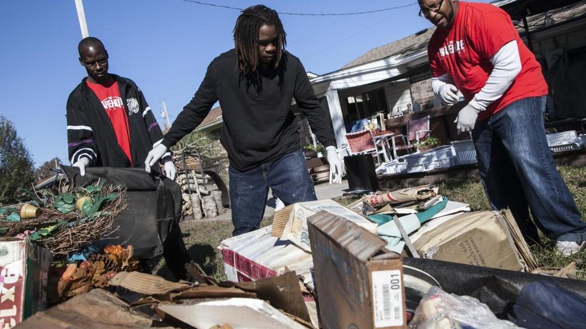 At-risk youth from the Warehouse Project led by pastor Stephen Brown (right) help residents remove debris in the Rosewood Community following Hurricane Matthew on Saturday, Nov. 5, 2016. The Warehouse Project seeks to teach life skills to at-risk youth by providing community service through the Horry County Solicitors office.