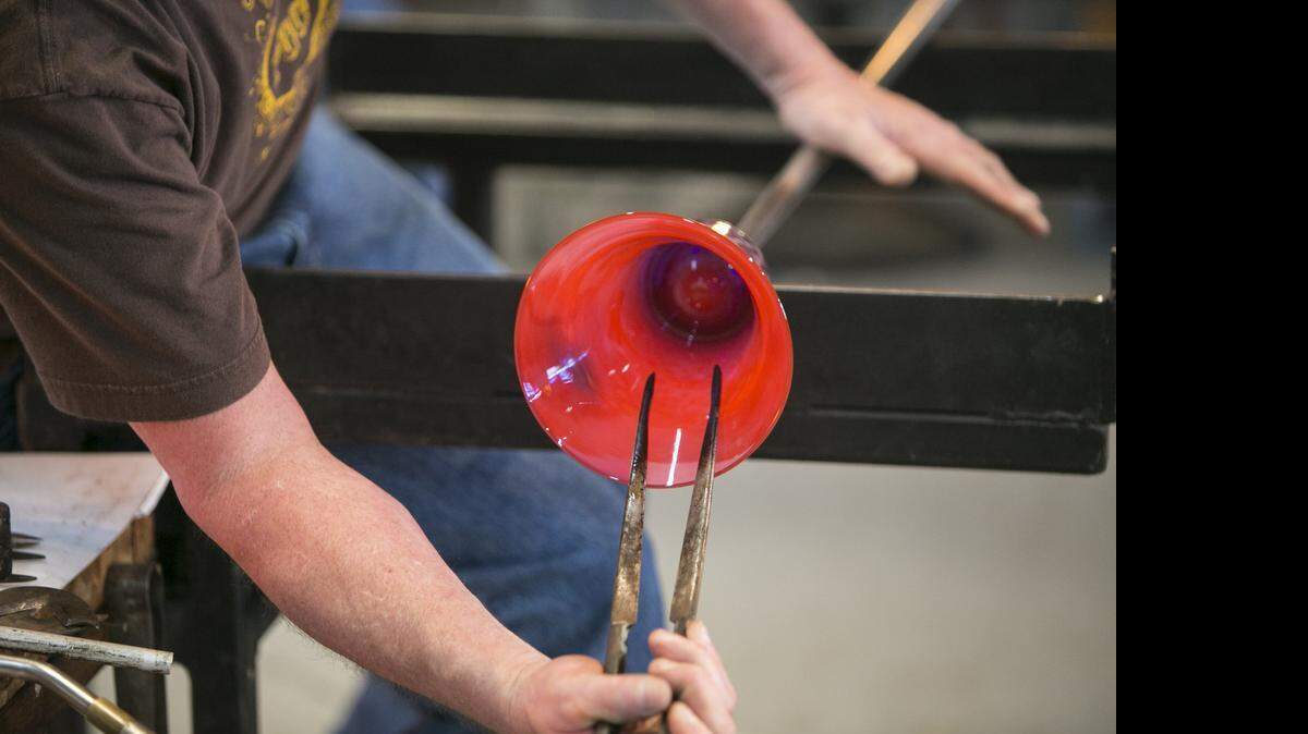 
Wayne Fitzgerald, a glass blower, visiting from Pennsylvania, gives a demonstration, repurposing old beer, liquor and soda bottles into works of art at Conway Glass. Dennis Stevens, along with Barbara and Ed Streeter, recently formed the Conway Cultural Development Corporation, an organization dedicated to spurring economic growth by creating a vibrant arts scene.
