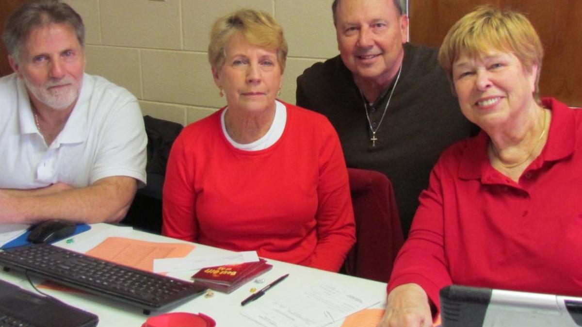 Four Volunteers, Mitch Hewett (left) of Holden Beach, N.C., Mary Fitzgerald of Ocean Isle Beach, N.C., Mary Pritchard of Carolina Shores, N.C. and John Mullins of Calabash, N.C., assist people who request food at Camp United Methodist Church food pantry in Shallotte, N.C.