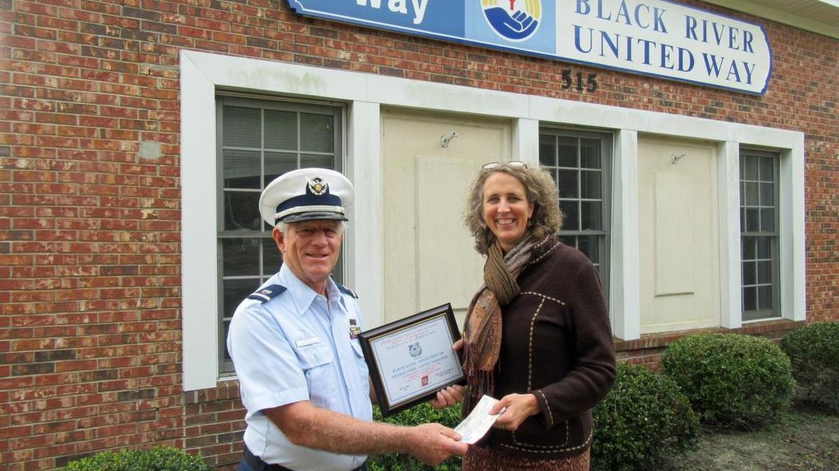 Bill Unger presenting certificate and check to Lucy Woodhouse